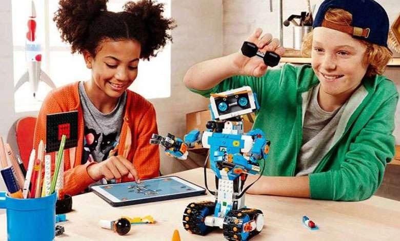 A boy and a girl playing with a tablet and a robot toy